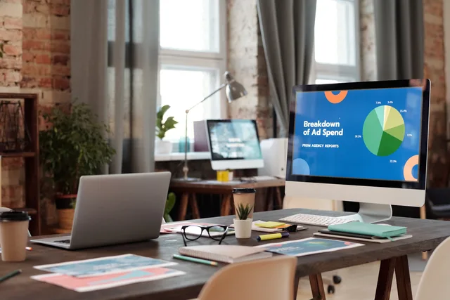 A modern office workspace featuring computers, charts, and office supplies for a productive environment. When to review programmatic advertising data protection