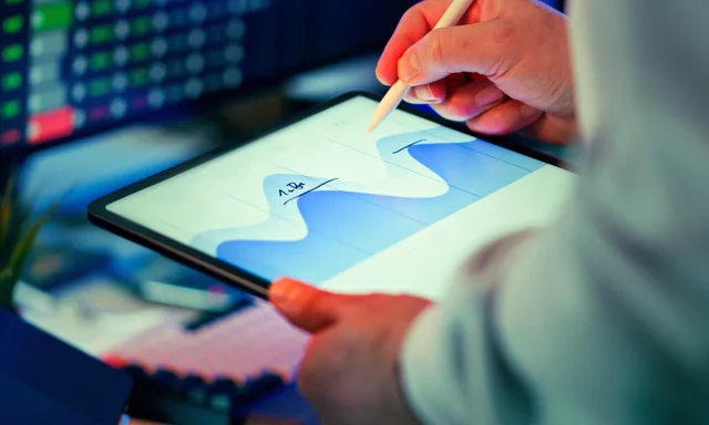 Professional analyzing data chart on a tablet with stylus in an office setting. Which programmatic advertising key metrics should an agency report?