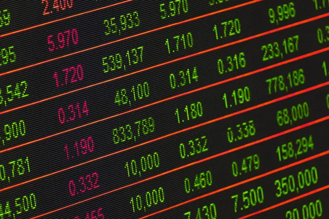 Close-up of a digital stock market data display showing colorful financial numbers and trends. Programmatic advertising CPM bands for eight UK regions